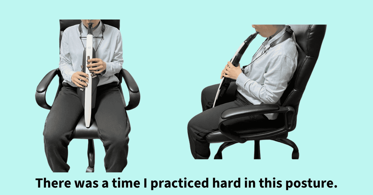 My old playing posture: sitting deep in an office chair with the instrument resting on the seat